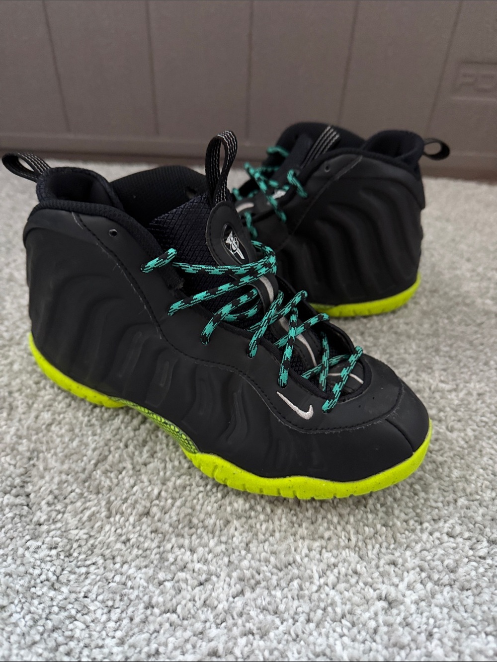 Nike Kids Black Sneakers with Neon Yellow Sole and Teal Laces